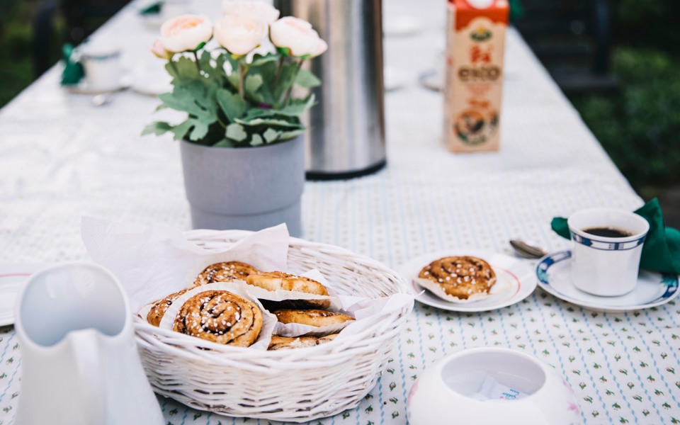 Ett fikabord med kaffe, bullar och mjölk.